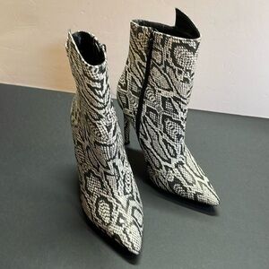 Express woman’s black/white snake skin print pointed toe ankle boots. Size 7.5.